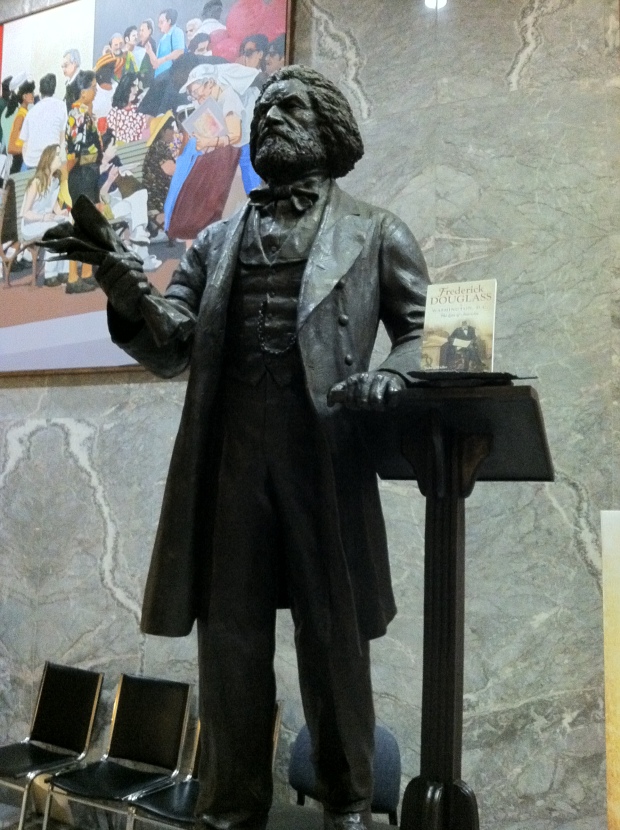 Before the Frederick Douglass statue at One Judiciary Square moves to the US Capitol he takes time to read a new book about his life and times in Anacostia. Photo_ John Muller
